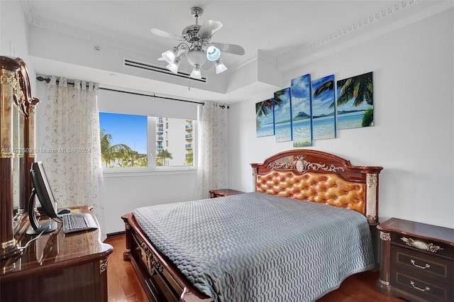 bedroom with dark hardwood / wood-style floors, ornamental molding, and ceiling fan