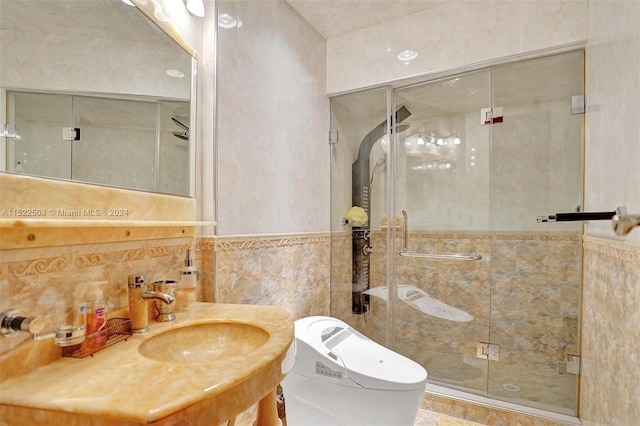 bathroom featuring backsplash, tile walls, a shower with door, and sink