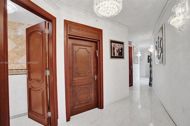 hallway with an inviting chandelier and light tile flooring