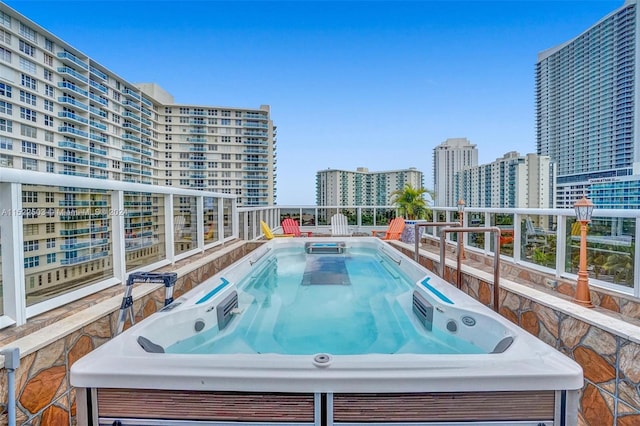 view of swimming pool featuring an outdoor hot tub