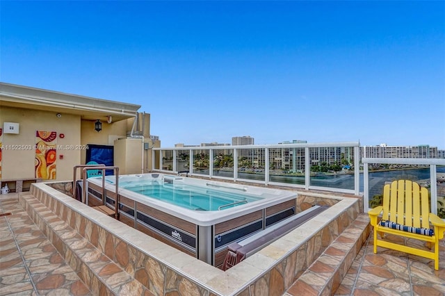 view of pool with an outdoor hot tub