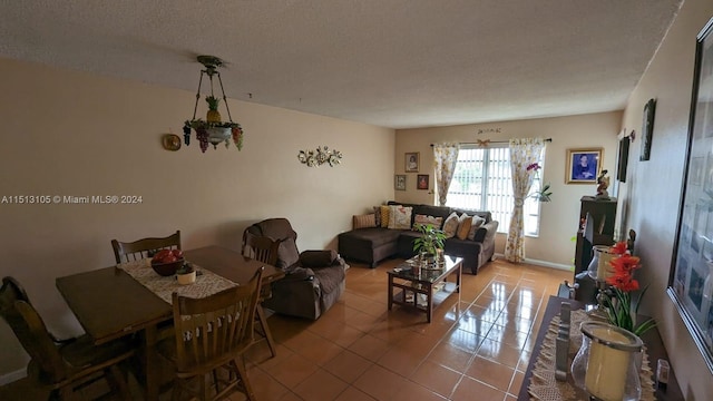 dining space with tile flooring and a textured ceiling