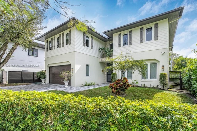 view of front of property with a front yard and a garage