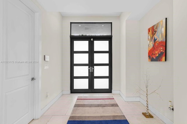 entrance foyer featuring french doors and light tile floors