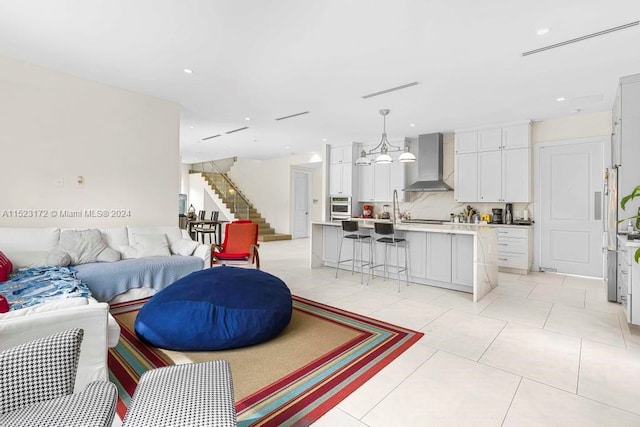 living room with light tile flooring and a notable chandelier