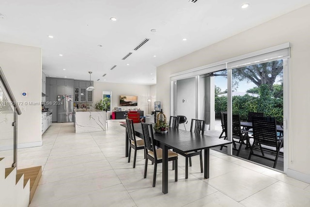 tiled dining space featuring plenty of natural light