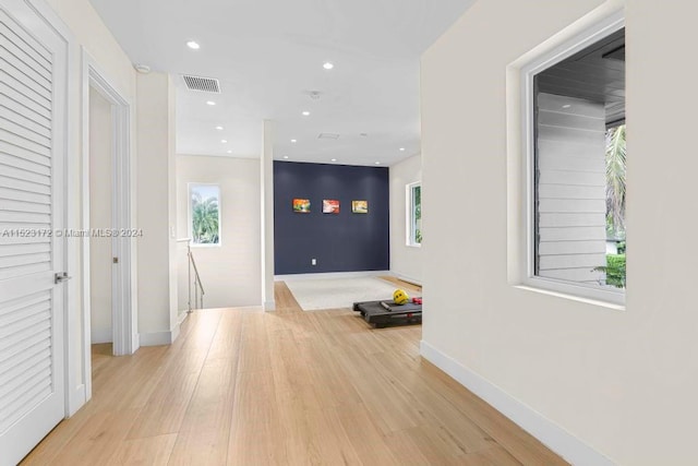 corridor with light wood-type flooring