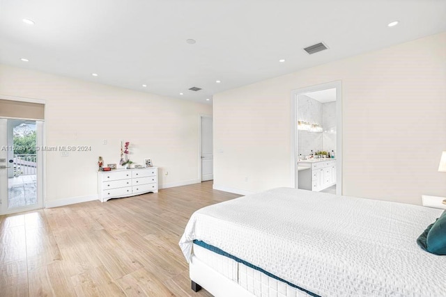 bedroom featuring light hardwood / wood-style floors, access to exterior, and ensuite bathroom