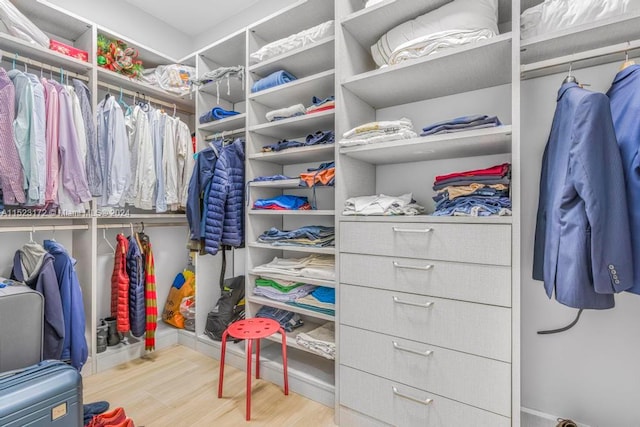 walk in closet with light wood-type flooring