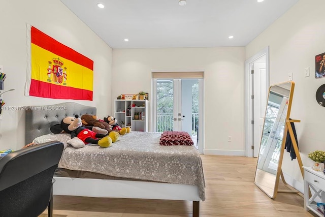 bedroom with french doors, light hardwood / wood-style floors, access to exterior, and multiple windows