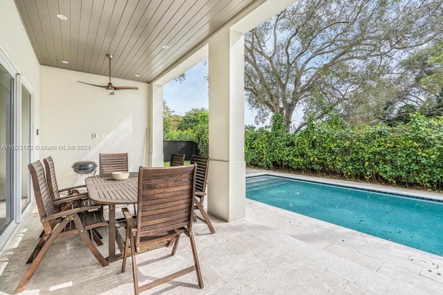 view of swimming pool featuring a patio and ceiling fan