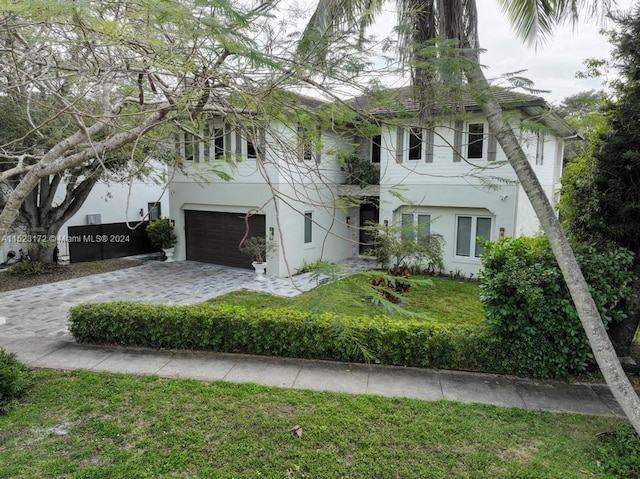 view of front facade featuring a front lawn and a garage