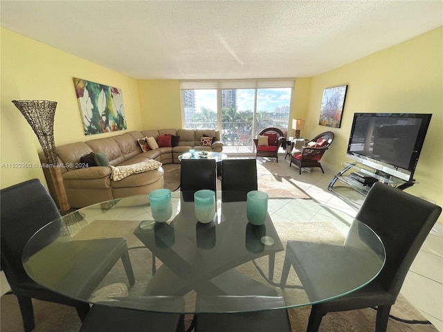 dining space featuring expansive windows and a textured ceiling