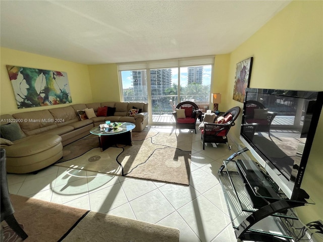 tiled living room featuring a textured ceiling