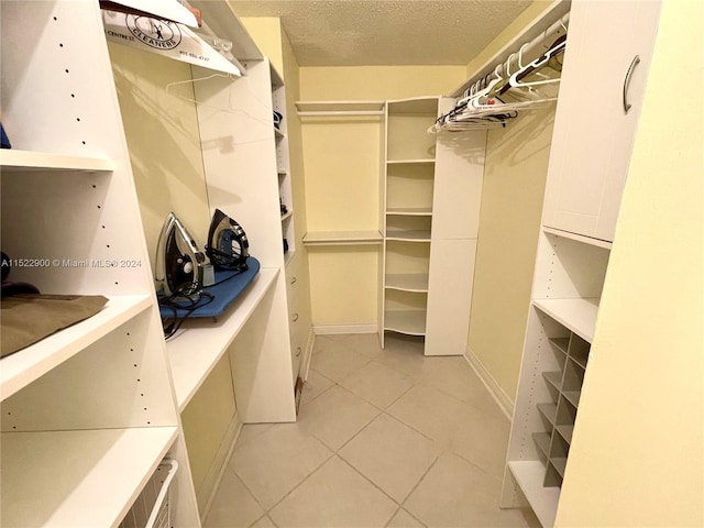 spacious closet featuring light tile floors