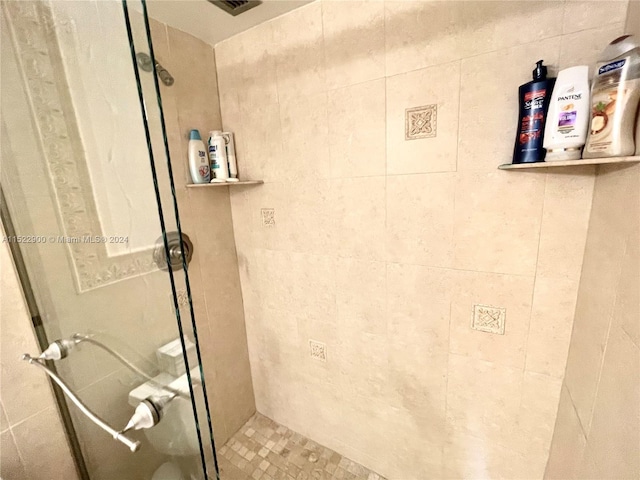 bathroom with a tile shower