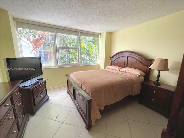 tiled bedroom featuring a textured ceiling