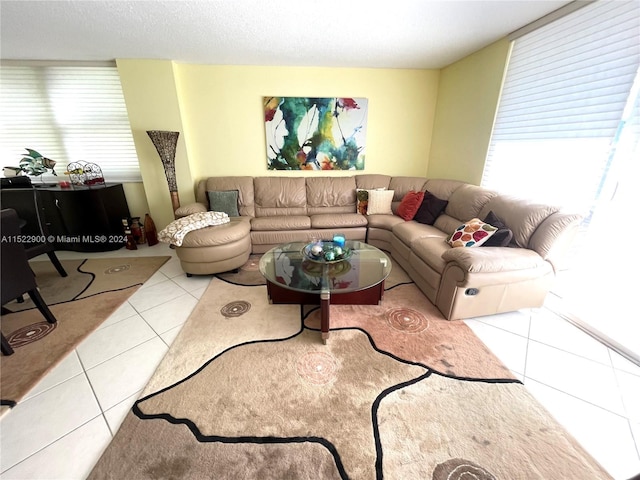 living room featuring light tile floors and a textured ceiling