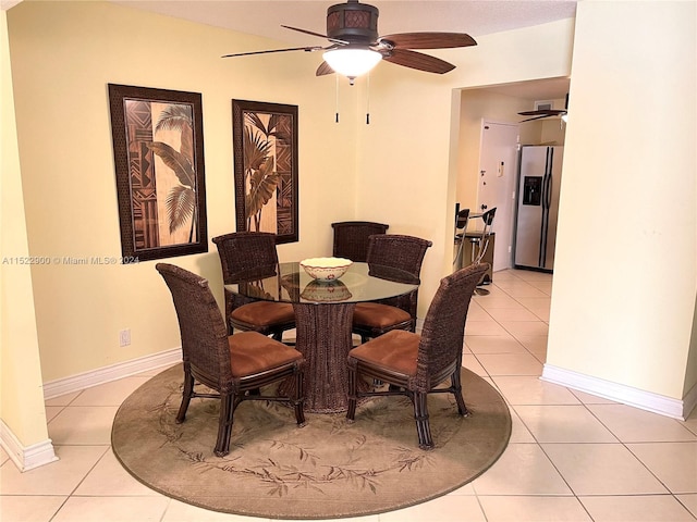 dining space with light tile floors and ceiling fan