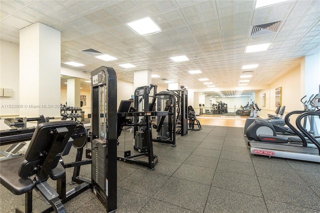 exercise room with a drop ceiling