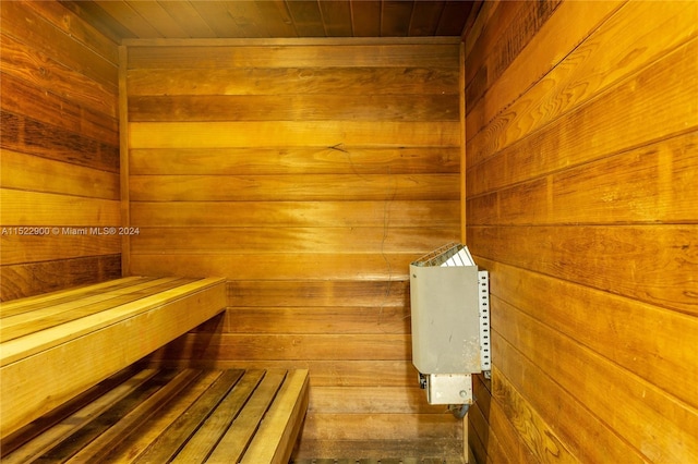 view of sauna with wood ceiling and wood walls