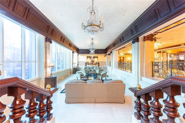 living room featuring crown molding, an inviting chandelier, and light tile floors