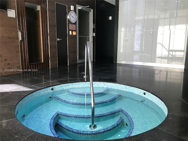 view of pool with an indoor hot tub