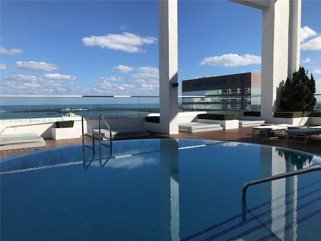 view of swimming pool with a water view