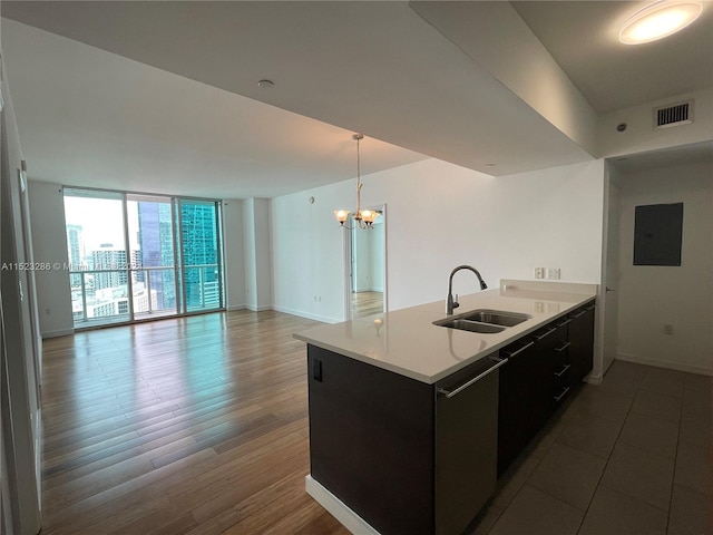 kitchen featuring a chandelier, pendant lighting, floor to ceiling windows, dark wood-type flooring, and sink