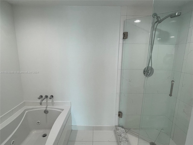 bathroom featuring shower with separate bathtub and tile floors