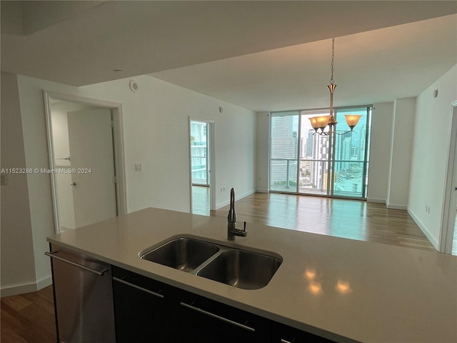 kitchen with hardwood / wood-style floors, decorative light fixtures, sink, and an inviting chandelier