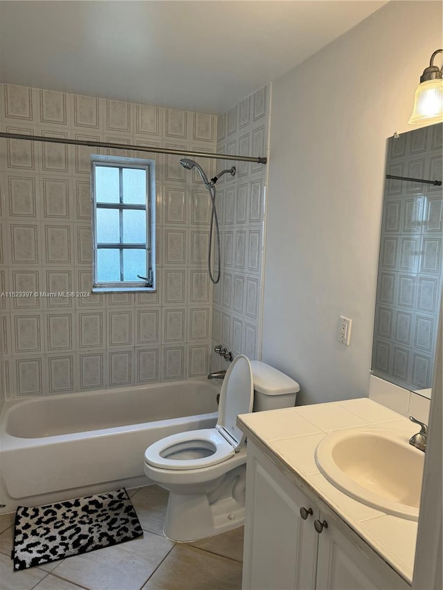 full bathroom featuring tile flooring, tiled shower / bath combo, toilet, and large vanity