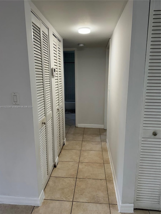 corridor with light tile flooring