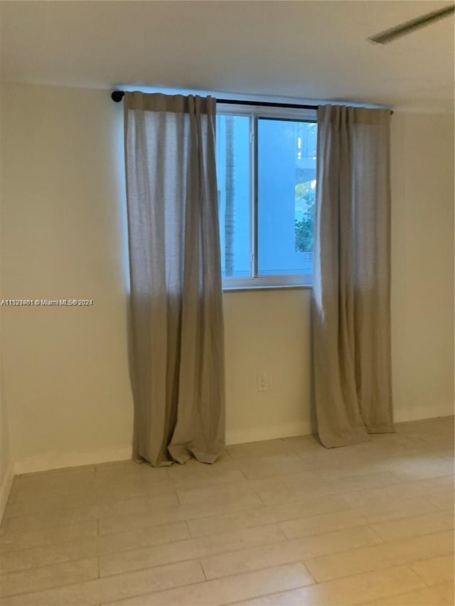 unfurnished room featuring light wood-type flooring