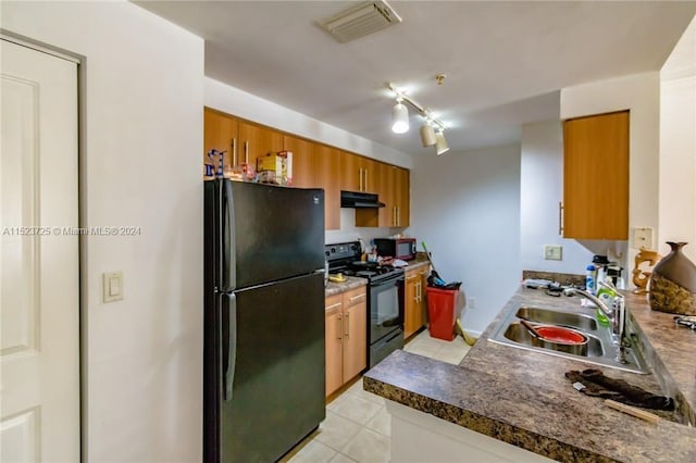 kitchen with rail lighting, light tile flooring, sink, and black appliances