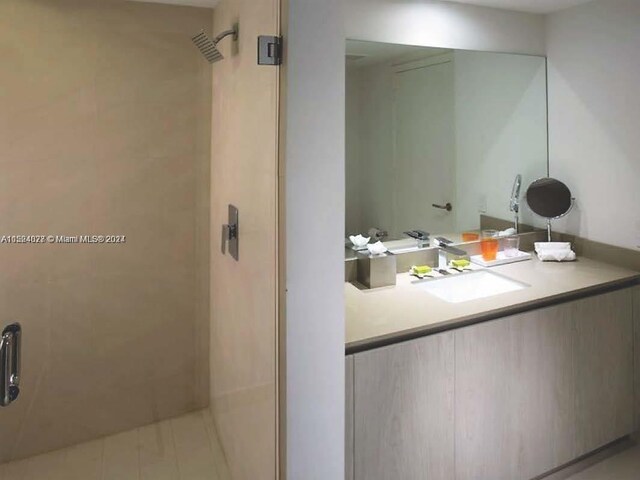 bathroom featuring vanity and a tile shower