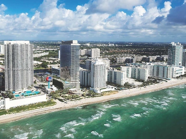 aerial view with a water view and a view of the beach