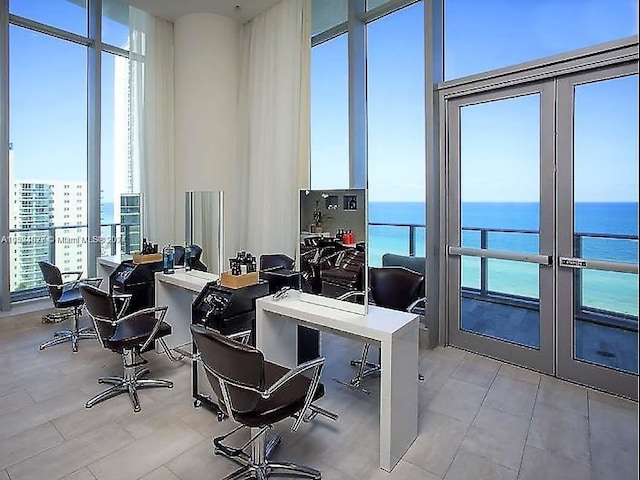 office space with french doors and a water view