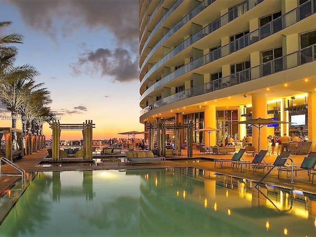 view of pool at dusk