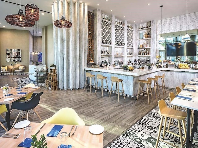 kitchen with a kitchen breakfast bar and dark hardwood / wood-style floors