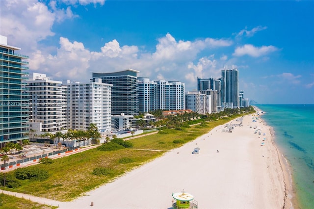 drone / aerial view featuring a view of the beach and a water view