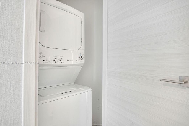 washroom featuring stacked washer / dryer