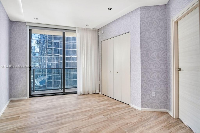 unfurnished bedroom with a closet and light hardwood / wood-style flooring