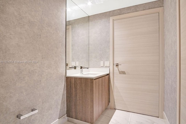 bathroom with vanity and tile flooring