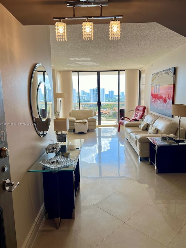 living room featuring a textured ceiling and a wall of windows