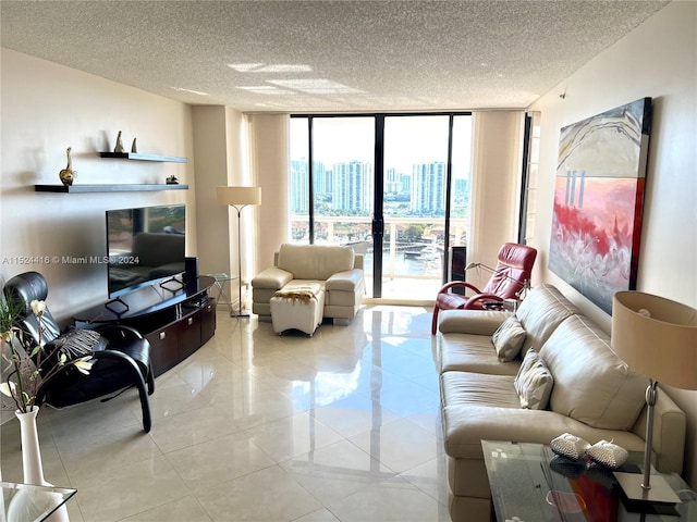 living room featuring light tile patterned floors, expansive windows, and a textured ceiling