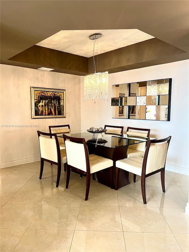 dining room featuring light tile patterned floors and a chandelier