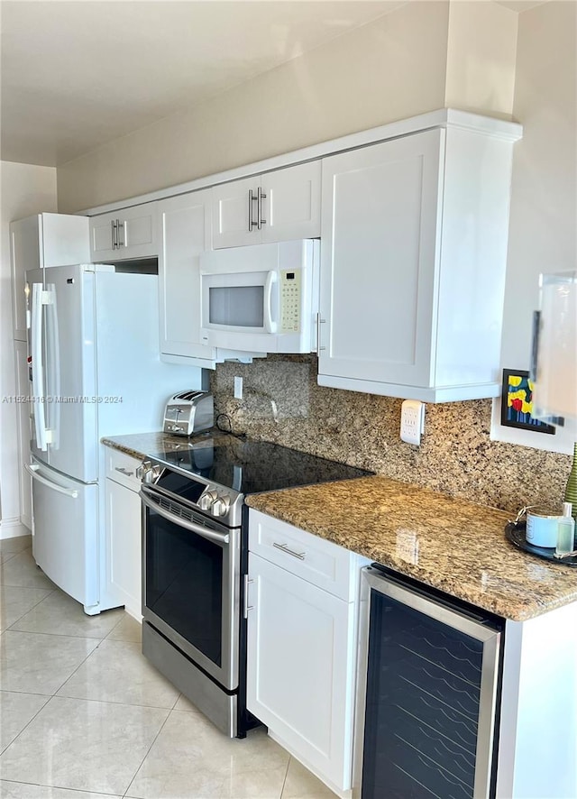 kitchen featuring backsplash, beverage cooler, electric range, stone counters, and white cabinetry