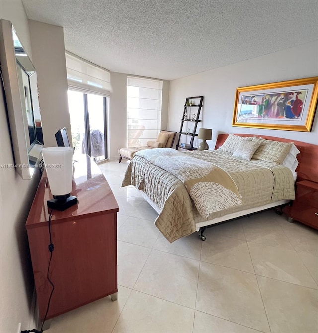 tiled bedroom featuring a textured ceiling