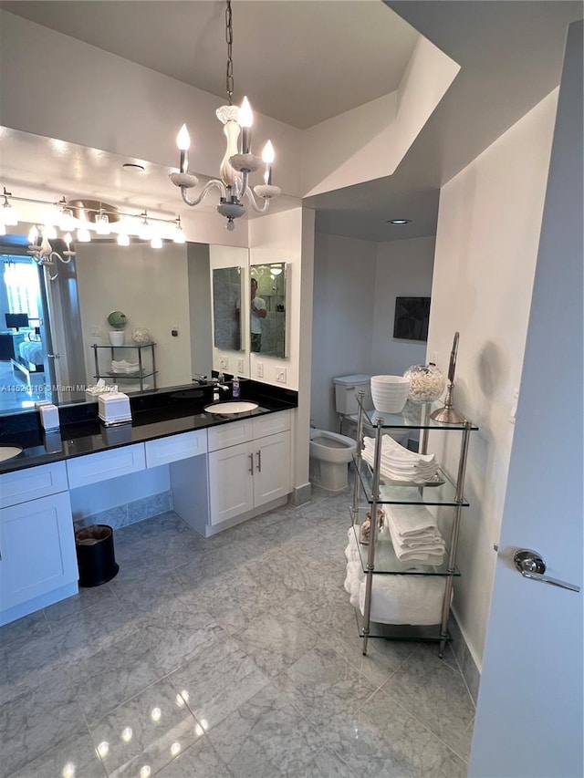 bathroom with vanity, a bidet, and a chandelier